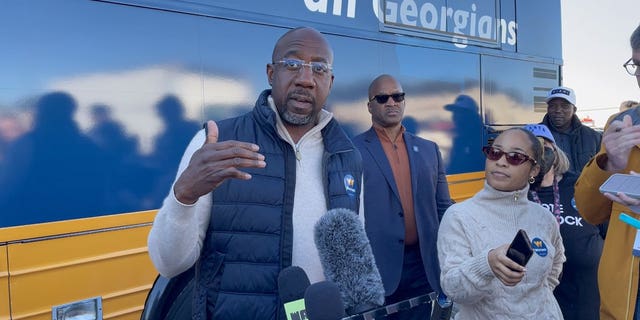 Democratic Georgia Sen. Raphael Warnock speaks with members of the media following a campaign rally in Conyers, Georgia on November 21, 2022.