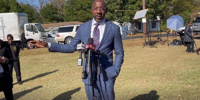 Democratic Georgia Sen. Raphael Warnock speaks with members of the media following a campaign rally in Fort Valley, Georgia on Nov. 17, 2022.