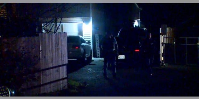 Authorities at the scene where a teenager was shot in the leg when a group of suspects opened fire on a house.