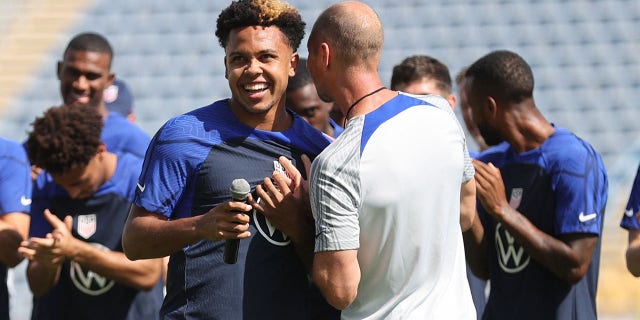 U.S. coach Gregg Berhalter with Weston McKennie during training.