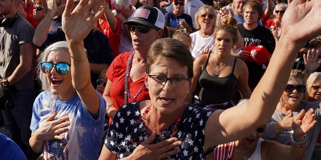 Supporters of former President Trump sing at a rally on Sept. 25, 2021, in Perry, Georgia.