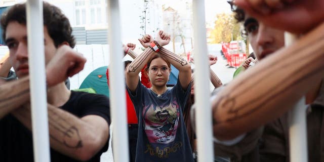 Students show their painted arms while being barricaded inside a school as a protest for climate change and against the use of fossil fuels in Lisbon, Portugal, November 12, 2022.