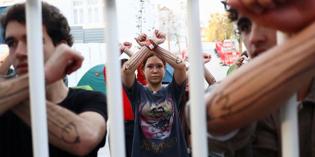 Students display their painted arms while barricaded inside a school as a protest against climate change and the use of fossil fuels in Lisbon, Portugal, November 12, 2022.