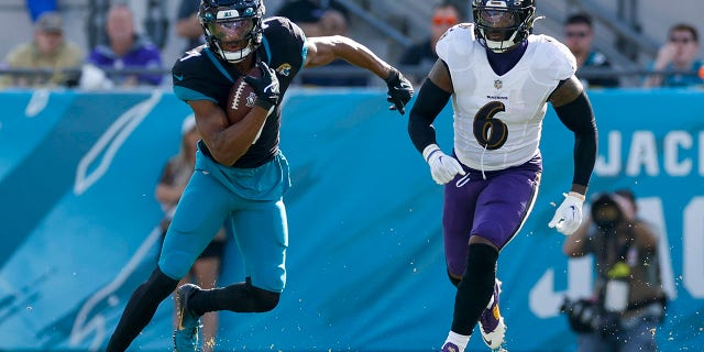 Jacksonville Jaguars wide receiver Zay Jones, left, runs with the ball during the game against the Baltimore Ravens, Nov. 27, 2022, at TIAA Bank Field in Jacksonville, Florida.