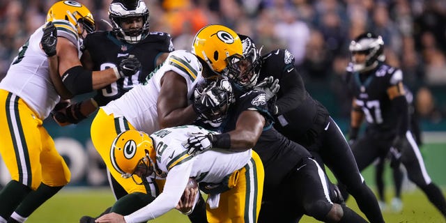 Fletcher Cox #91 of the Philadelphia Eagles fires Aaron Rodgers #12 of the Green Bay Packers during the second quarter at Lincoln Financial Field on November 27, 2022 in Philadelphia, Pennsylvania.