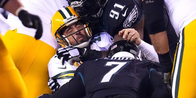 Aaron Rodgers #12 of the Green Bay Packers is sacked by Brandon Graham #55 of the Philadelphia Eagles during the 3rd quarter at Lincoln Financial Field on November 27, 2022 in Philadelphia, Pennsylvania.