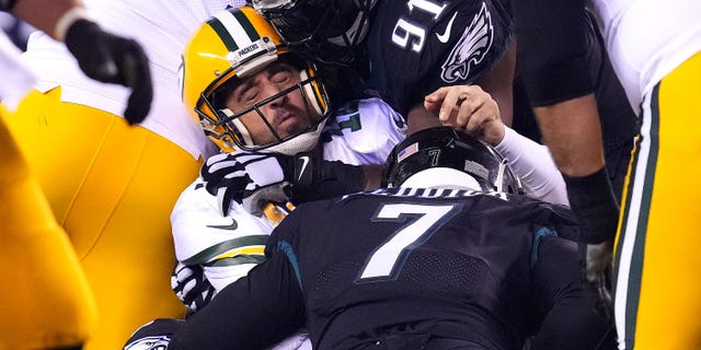 Aaron Rodgers #12 of the Green Bay Packers is sacked by Brandon Graham #55 of the Philadelphia Eagles during the third quarter at Lincoln Financial Field on November 27, 2022 in Philadelphia, Pennsylvania.