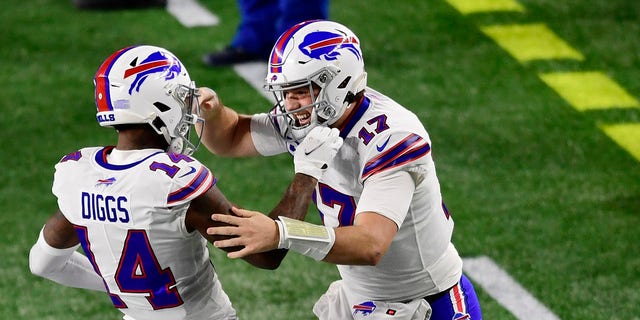 Josh Allen, b.  17, of the Buffalo Bills, celebrates with Stefon Diggs, no.  14, after a Diggs touchdown during the first half against the New England Patriots at Gillette Stadium on December 28, 2020, in Foxborough, Massachusetts. 