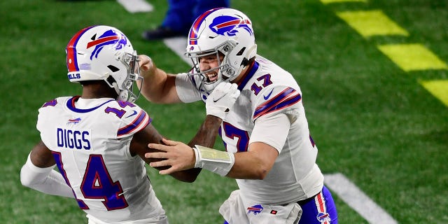Josh Allen, #17, of the Buffalo Bills, celebrates with Stefon Diggs, #14, after Diggs' touchdown during the first half against the New England Patriots at Gillette Stadium on December 28, 2020, in Foxborough, Massachusetts.