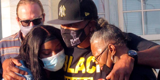 Hasani Best's family embraces one another after a grand jury decided to not bring charges against the police officer who killed their family member during a 45-minute standoff.