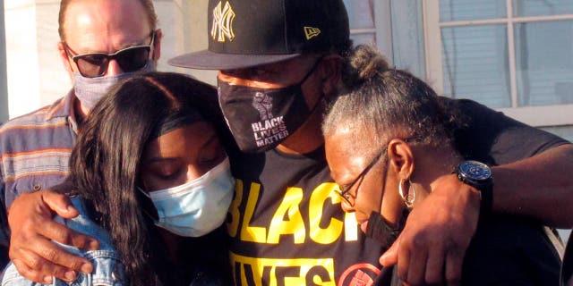 The Hosni Best family hugs each other after a grand jury decided not to press charges against the police officer who killed a member of his family during a 45-minute standoff.