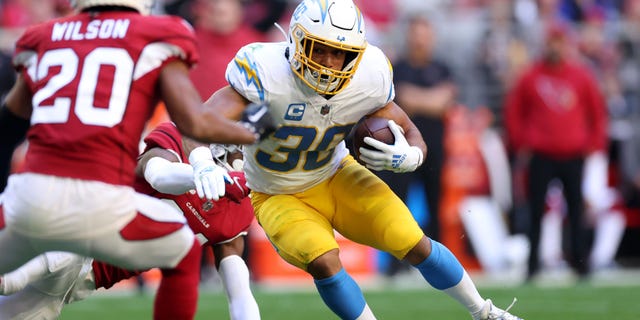 Austin Ekeler of the Los Angeles Chargers gains yards during the second quarter against the Arizona Cardinals at State Farm Stadium on Nov. 27, 2022, in Glendale, Arizona.