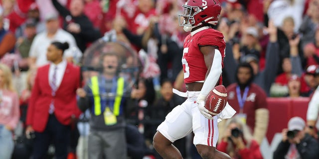 Roydell Williams #5 of the Alabama Crimson Tide reacts as he runs for a score against the Auburn Tigers during the first half at Bryant-Denny Stadium on November 26, 2022 in Tuscaloosa, Alabama.