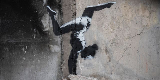 A mural by British street artist Banksy is displayed on a war-torn building in Borodyanka, Kyiv region, Ukraine, on Nov. 13, 2022.