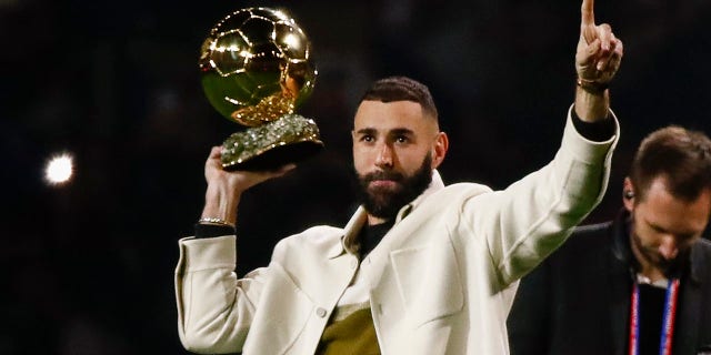 Karim Benzema, former Olympique Lyonnais player, presents his Ballon d'Or to the fans during a Ligue 1 match between Olympique Lyonnais and OGC Nice at Groupama Stadium Nov. 11, 2022, in Lyon, France.