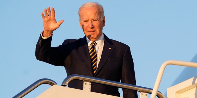 President Biden waves as he boards Air Force One at Andrews Air Force Base in Maryland Monday.