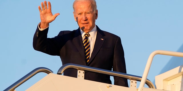 President Biden waves as he boards Air Force One at Andrews Air Force Base in Maryland on Monday.