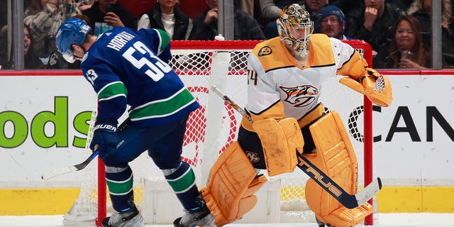 Bo Horvat (53) of the Vancouver Canucks skates past goalie Juuse Saros of the Nashville Predators after losing the puck during a shootout at Rogers Arena, Nov. 5, 2022, in Vancouver, British Columbia, Canada.