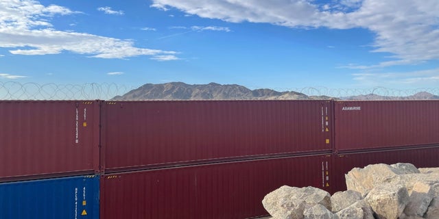 Arizona Gov. Doug Ducey filled the gaps in an unfinished section of the border wall with shipping containers covered in barbed wire outside of Yuma.