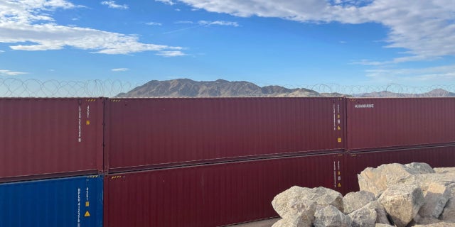 Arizona Gov. Doug Ducey filled the gaps in an unfinished section of the border wall with shipping containers covered in barbed wire outside of Yuma.