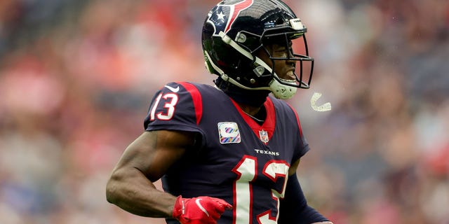 Brandin Cooks, #13 of the Houston Texans, reacts after hauling a catch in the first quarter against the Los Angeles Chargers at NRG Stadium on October 2, 2022 in Houston.