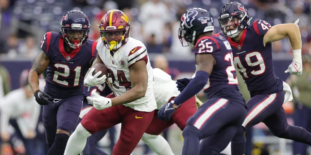 Antonio Gibson (24) of the Washington Commanders runs with the ball in the fourth quarter against the Houston Texans at NRG Stadium on Nov. 20, 2022, in Houston.