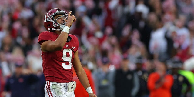 Bryce Young #9 of the Alabama Crimson Tide reacts after passing for a touchdown to Traeshon Holden #11 against the Auburn Tigers during the first half at Bryant-Denny Stadium on November 26, 2022 in Tuscaloosa, Alabama. 