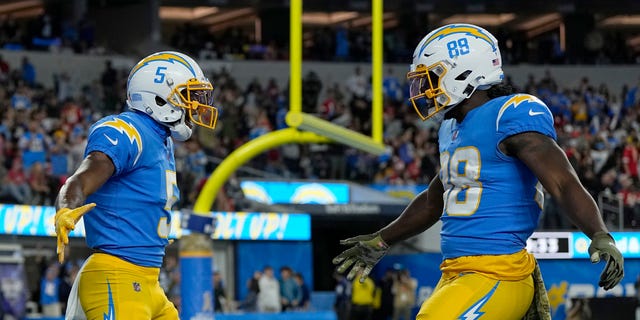 Joshua Palmer, left, of the Los Angeles Chargers celebrates a touchdown with Donald Parham Jr. during the Kansas City Chiefs game at SoFi Stadium on Nov. 20, 2022, in Inglewood, California.