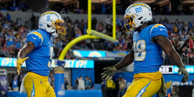 Joshua Palmer, left, of the Los Angeles Chargers celebrates a touchdown with Donald Parham Jr. during the Kansas City Chiefs game at SoFi Stadium on Nov. 20, 2022, in Inglewood, California.