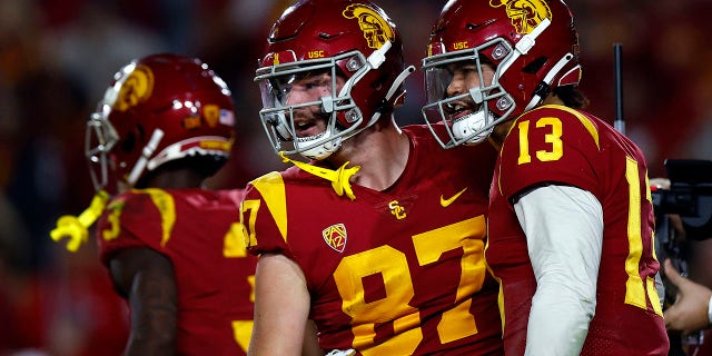 Caleb Williams #13 and Lake McRee #87 of the USC Trojans celebrate a touchdown against the Notre Dame Fighting Irish in the first half at United Airlines Field at the Los Angeles Memorial Coliseum on November 26, 2022 in Los Angeles, California. 