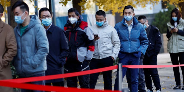 Chinese citizens line up for COVID tests in Beijing.