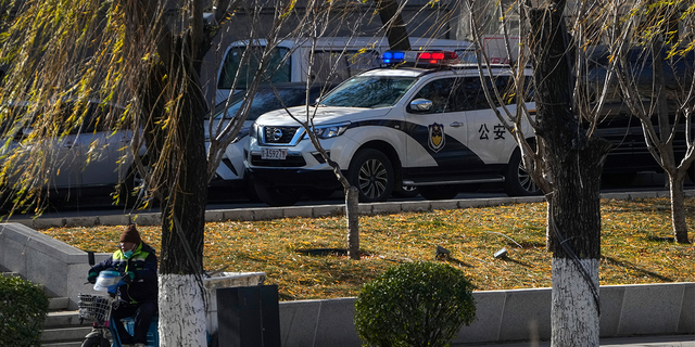A police vehicle patrols along the riverbank near the site of last weekend's protest in Beijing.