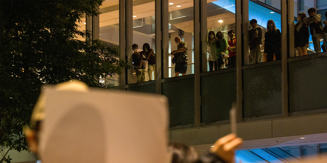 People watch from above at a protest gathering at the University of Hong Kong.