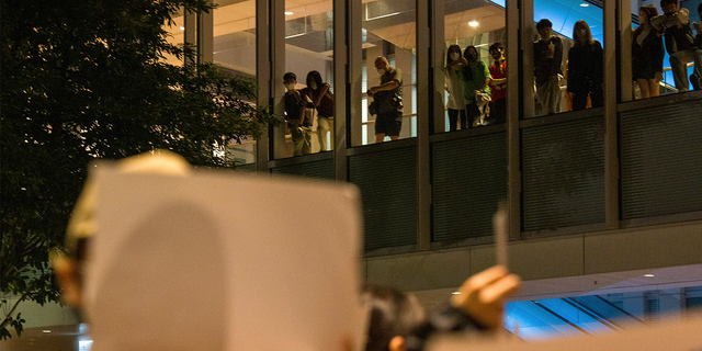 People watch from above at a protest gathering at the University of Hong Kong.