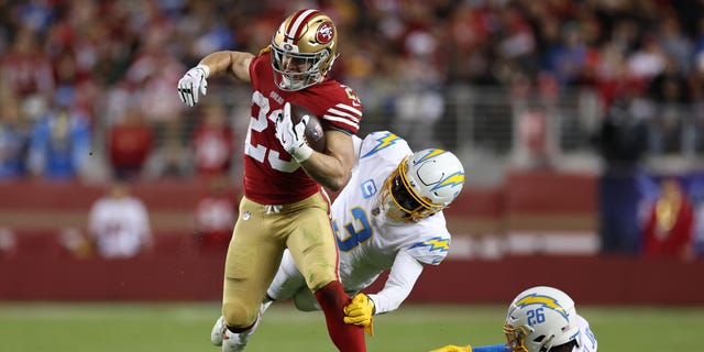 Christian McCaffrey, number 23 of the San Francisco 49ers, runs in the third quarter against the Los Angeles Chargers on November 13, 2022, at Levi's Stadium in Santa Clara, California. 