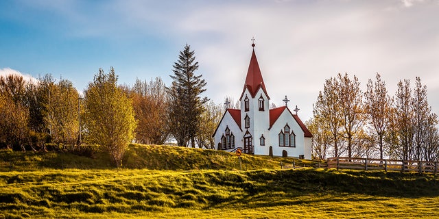 Beautiful white Scandinavian church in Iceland at sunrise