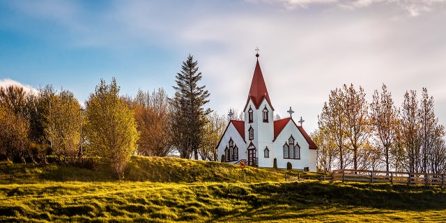 Beautiful white Scandinavian church in Iceland at sunrise