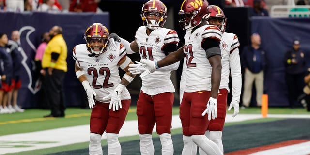 Darrick Forrest (22) of the Washington Commanders celebrates an interception with teammates in the fourth quarter against the Houston Texans at NRG Stadium on Nov. 20, 2022, in Houston.