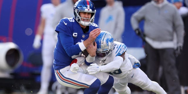 Jerry Jacobs of the Detroit Lions tackles Daniel Jones of the New York Giants during the first half at MetLife Stadium on Nov. 20, 2022, in East Rutherford, New Jersey.