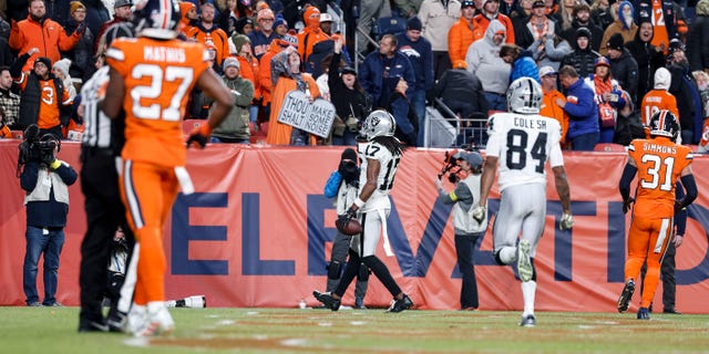 Davante Adams, #17 of the Las Vegas Raiders, completes a pass and runs for a touchdown to win in overtime during an NFL game between the Las Vegas Raiders and Denver Broncos at Empower Field At Mile High on Nov. 20, 2022 in Denver.