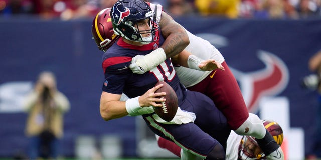 Davis Mills (10) of the Houston Texans is sacked against the Washington Commanders at NRG Stadium on Nov. 20, 2022, in Houston.
