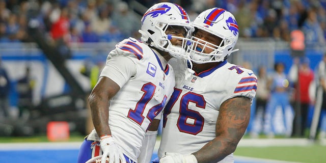 Buffalo Bills wide receiver Stefon Diggs (14) is greeted by guard Rodger Saffold after a 5-yard reception for a touchdown during the second half of an NFL football game against the Detroit Lions, Thursday, Nov. 24, 2022, in Detroit.