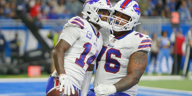 Buffalo Bills wide receiver Stefon Diggs (14) is greeted by guard Rodger Saffold after a 5-yard reception for a touchdown during the second half of an NFL football game against the Detroit Lions, Thursday, Nov. 24, 2022, in Detroit.