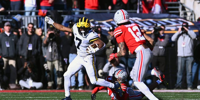 Donovan Edwards (7) of the Michigan Wolverines evades a tackle during the second quarter of a game against the Ohio State Buckeyes at Ohio Stadium Nov. 26, 2022, in Columbus, Ohio. 