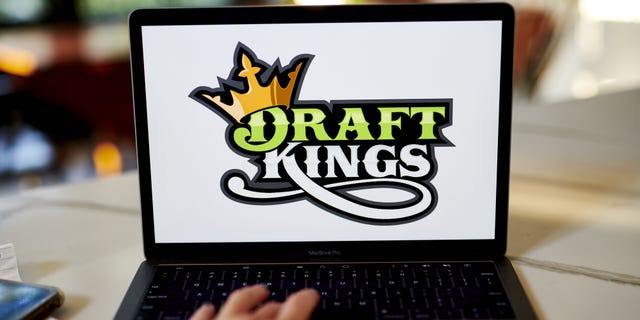 The logo for DraftKings is displayed on a laptop computer in an arranged photograph taken in Little Falls, New Jersey, U.S., on Wednesday, Oct. 7, 2020. The pricing of a DraftKings Inc. share sale combined with a fresh wave of Covid-19 infections across the National Football League sent shares of the online gaming company tumbling this week.