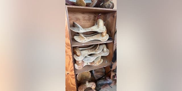 A stack of saddle trees are shown in Drew Clark's work space. The saddle trees are "wood covered with rawhide," he said.