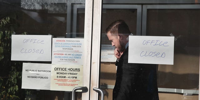 People believed to be federal agents leave the office of 14th Ward Alderman Ed Burke, where boxes of documents and computer equipment were taken November 29, 2018, in Chicago. The FBI has confirmed that a search warrant was executed at the alderman's offices.