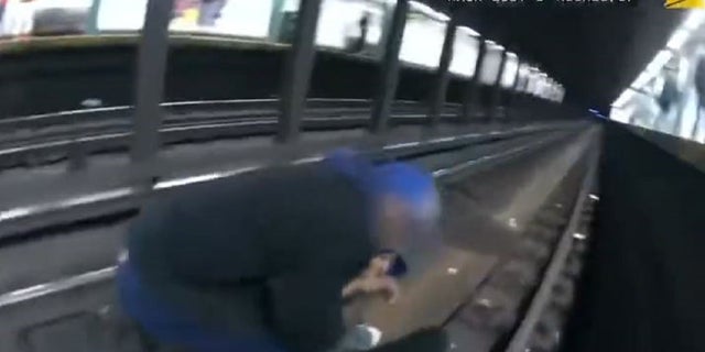 NYPD officers rushed to rescue a man who had fallen onto Manhattan subway train tracks Thursday.