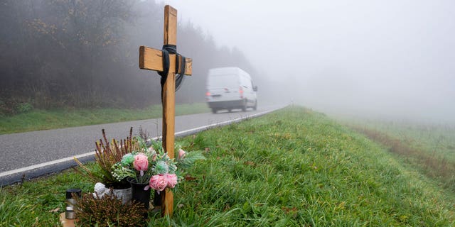 A wooden memorial cross stands at the spot where two police officers were killed in the line of duty at the end of January 2022 near the town Kusel, Germany, on Nov. 29, 2022.