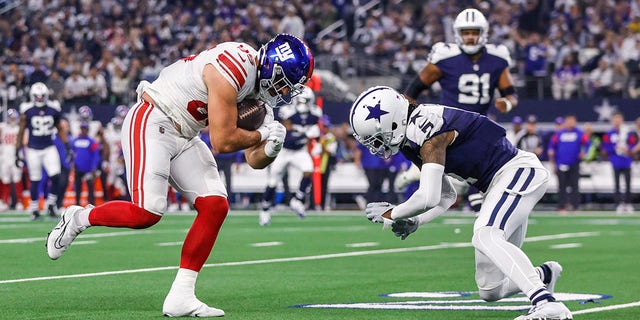 New York Giants fullback Chris Myarick (85) catches a pass for a first down and gets tackled by Dallas Cowboys cornerback Trevon Diggs (7) during a game Nov. 24, 2022, in Arlington, Texas.